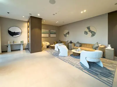 a living room with a couch and tables and chairs at Grande Signature Residence 907 Full Burj Khalifa and Dubai Dancing Fountain View 5 Min Walk Dubai Mall Luxury Downtown Apartment in Dubai
