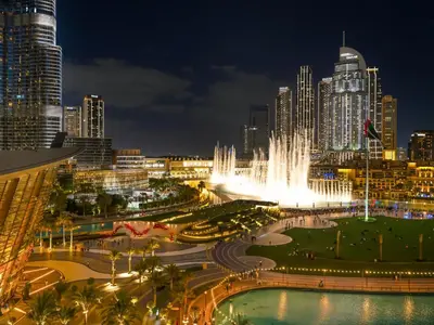 a city skyline at night with a fountain at Grande Signature Residence 907 Full Burj Khalifa and Dubai Dancing Fountain View 5 Min Walk Dubai Mall Luxury Downtown Apartment in Dubai