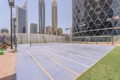 a tennis court in the middle of a city at StayShort - Stylish DIFC Apartment Sleeps 4 with Pool & Gym in Dubai