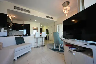a living room with a couch and a large television at Damac Maison Mall Street,Burj Khalifa in Dubai