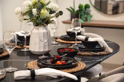 a table with plates of food and wine glasses at Elegant 2BR Apartment near Burj Khalifa, Downtown Dubai in Dubai