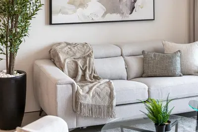 a living room with a couch with a blanket at Address JBR, 57th Floor Luxury Marina Beach View in Dubai