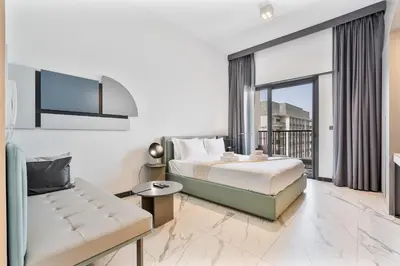 a hotel room with a bed and a couch at PVH - Serene Studio minutes to Downtown - MAG Eye in Dubai