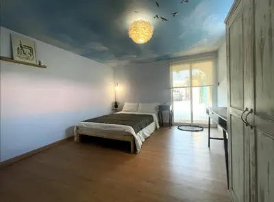 a bedroom with a bed and a chandelier at Palm Oasis Guest House in Dubai
