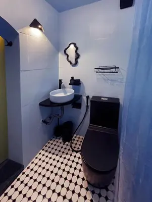 a small bathroom with a sink and a toilet at Palm Oasis Guest House in Dubai