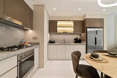 a kitchen with a table and chairs and a counter at Werova - Luxury 2-Bedroom Apartment with Sea View in Dubai