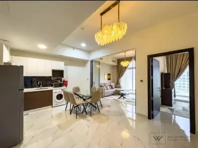 a kitchen and dining room with a table and chairs at Huge luxurious 1 bedroom in Dubai