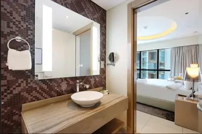 a bathroom with a sink and a mirror at Stylish 2BR Paramount Apt Near Downtown in Dubai