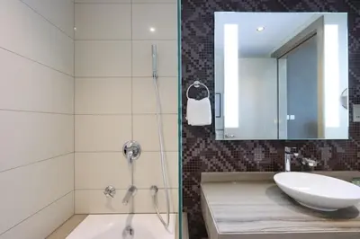 a bathroom with a sink and a mirror at Stylish 2BR Paramount Apt Near Downtown in Dubai