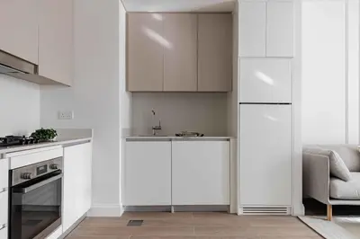 a kitchen with white cabinets and a sink at Waterfront View, Boutique apartment, Lagoon Access in Dubai