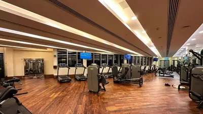 a gym with a lot of treadmills and machines at Panoramic Burj Khalifa Views - Modern & Comfy Gem in Dubai