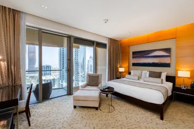 a bedroom with a large bed and a large window at Panoramic Burj Khalifa Views - Modern & Comfy Gem in Dubai
