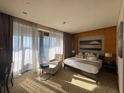 a bedroom with a bed and a couch and a chair at Panoramic Burj Khalifa Views - Modern & Comfy Gem in Dubai