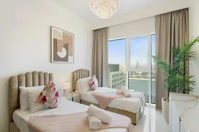 a hotel room with two beds and a balcony at Elegant 2BR in Beachfront with Stunning Marina Views in Dubai
