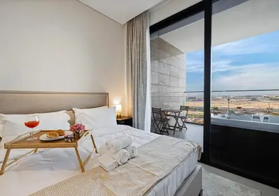 a bedroom with a bed with a table with a tray of food at Livin' Holidays - Studio - Canal view with jacuzzi in Dubai