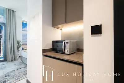 a kitchen with a microwave and a counter top at LUX The Northside Studio in Dubai