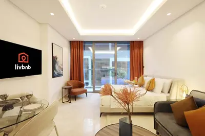 a living room with a couch and a table at Modern Studio Near Dubai Mall Walk to Dubai Canal in Dubai