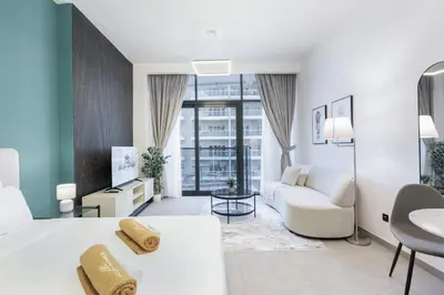 a living room with a bed and a couch at Modern Home in Sports City with Rooftop Pool in Dubai