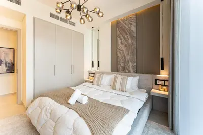 a bedroom with a large bed with white sheets and pillows at HAVN - Luxurious 4 Bed Villa in Arabian Ranches 3 in Dubai