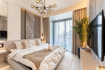 a bedroom with a large bed and a large window at HAVN - Luxurious 4 Bed Villa in Arabian Ranches 3 in Dubai