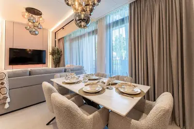a dining room with a table and chairs and a couch at HAVN - Luxurious 4 Bed Villa in Arabian Ranches 3 in Dubai