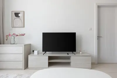 a living room with a flat screen tv on a entertainment center at Stylish One-Bedroom Oasis - Prime Palm Location in Dubai