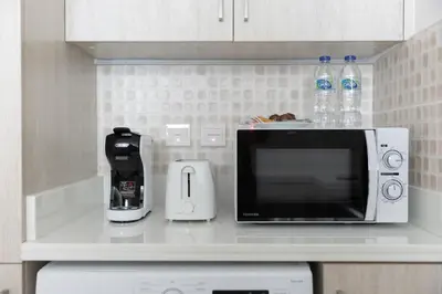 a microwave sitting on a counter in a kitchen at Stylish One-Bedroom Oasis - Prime Palm Location in Dubai