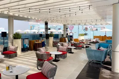 a restaurant with tables and chairs and tables and chairs at Stylish One-Bedroom Oasis - Prime Palm Location in Dubai