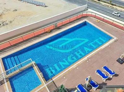 an overhead view of a swimming pool with blue chairs at Pool View 1BR with Spacious Balcony, Short Drive to Downtown, Binghatti Gateway, Al Jaddaf by Deluxe Holiday Homes in Dubai