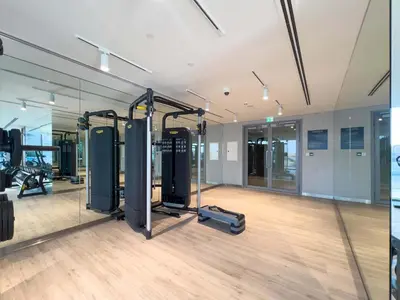 a gym with treadmills and machines in a room at Luxury 2BR and Study Water View in Al Wasl in Dubai