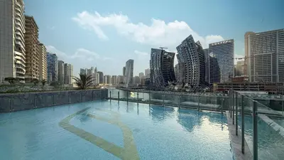a large swimming pool on top of a city skyline at Luxury 2BR with Canal View Burj Khalifa view and Infinity Pool Access in Dubai