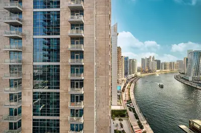 a view of a river in a city with buildings at Luxury 2BR with Canal View Burj Khalifa view and Infinity Pool Access in Dubai