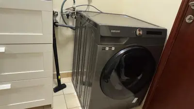 a washing machine in a room with a cabinet at Marina View Luxury Retreat Modern Apartment JBR Dubai in Dubai