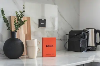 a kitchen counter with a vase and a book on it at GuestReady - Stunning unit at Binghatti House in Dubai