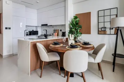 a kitchen with a wooden table and chairs at GuestReady - Stunning unit at Binghatti House in Dubai