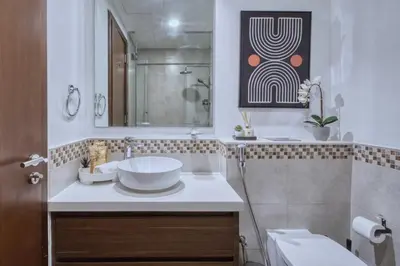 a white bathroom with a sink and a mirror at GuestReady - Sleek city retreat in Business Bay in Dubai
