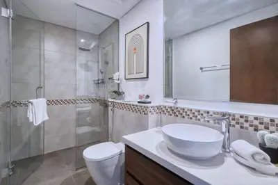 a bathroom with a sink and a toilet and a shower at GuestReady - Sleek city retreat in Business Bay in Dubai