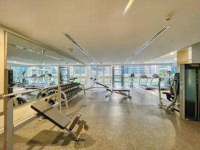 a gym with several treadmills and machines in it at GuestReady - Sleek city retreat in Business Bay in Dubai