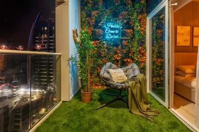 a room with a chair in front of a wall of flowers at GuestReady - Sleek city retreat in Business Bay in Dubai