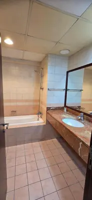 a bathroom with two sinks and a bath tub at Westin Marina in Dubai