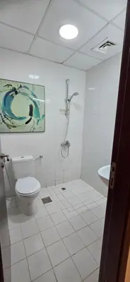a bathroom with a toilet and a shower and a sink at Westin Marina in Dubai