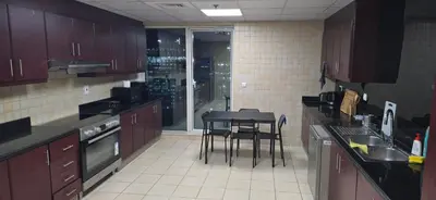 a kitchen with a table and chairs in it at Westin Marina in Dubai