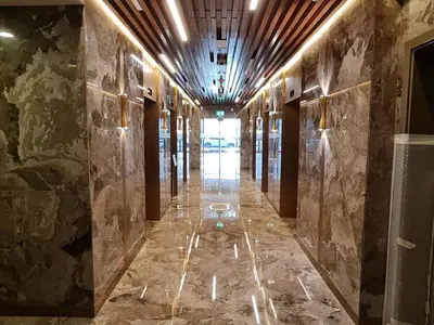 a hallway in a building with marble walls and lights at Westin Marina in Dubai