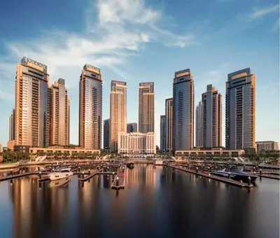 a city with a harbor with boats in the water at DB HOMs in Dubai