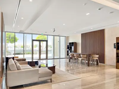 a living room with a couch and a table at Silkhaus Charming 1BDR in Canal Front Tower in Dubai