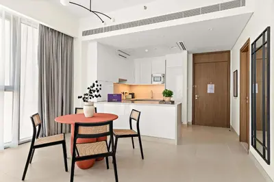 a kitchen and dining room with a table and chairs at Silkhaus Elite 1BDR in Canal Front Tower in Dubai