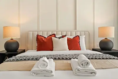 a bedroom with a bed with towels on it at Silkhaus Elite 1BDR in Canal Front Tower in Dubai