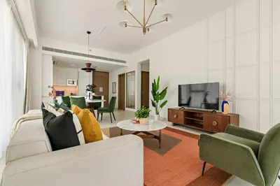 a living room with a couch and a tv at Silkhaus Luxury 1BDR Stay in Canal Front, Al Wasl in Dubai