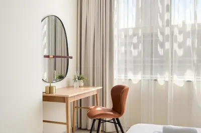 a bedroom with a desk and a mirror and a chair at Silkhaus Elegant 1BDR in Sky gardens with Metro Access in Dubai