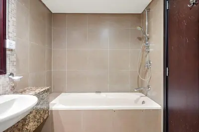 a bathroom with a bath tub and a sink at Silkhaus Exclusive 1BDR Stay at Sky Gardens in DIFC in Dubai